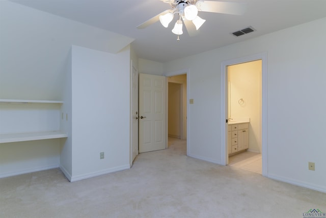 unfurnished bedroom with connected bathroom, ceiling fan, and light carpet