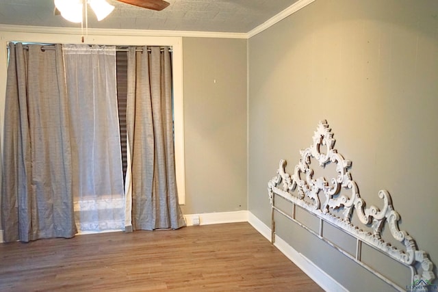 interior space featuring wood-type flooring, ceiling fan, and ornamental molding