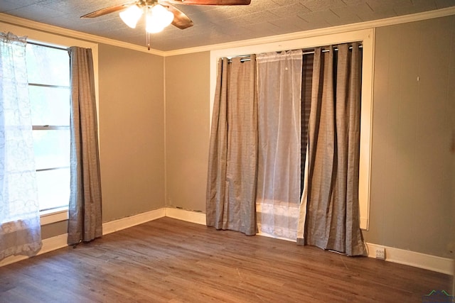 unfurnished room with ceiling fan, wood-type flooring, and ornamental molding