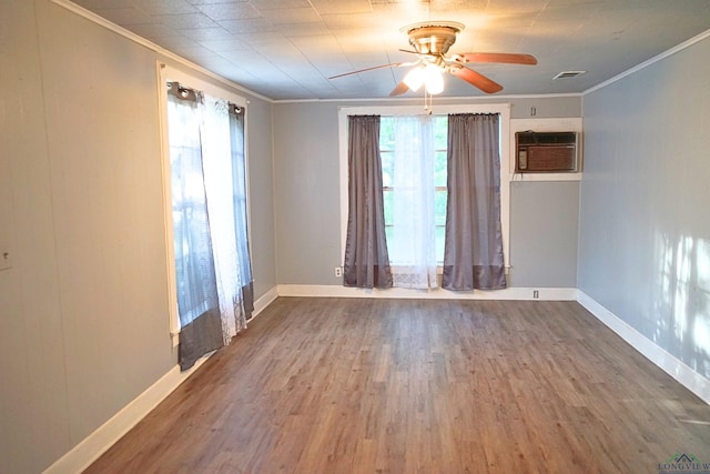 unfurnished room with hardwood / wood-style flooring, a wall mounted AC, crown molding, and ceiling fan