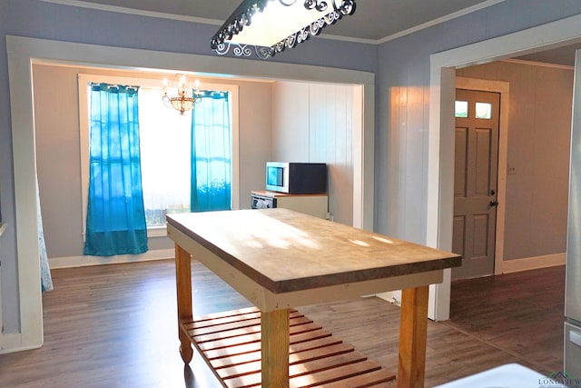 unfurnished dining area featuring an inviting chandelier and crown molding