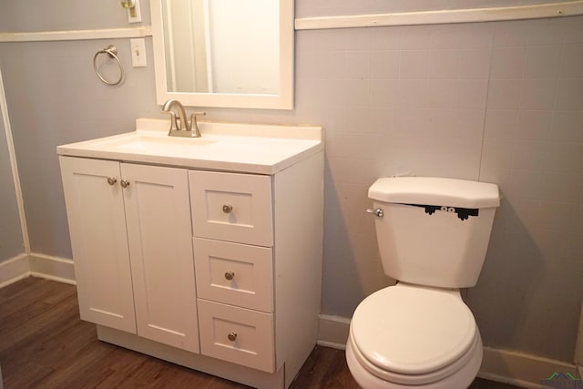 bathroom featuring hardwood / wood-style floors, vanity, and toilet