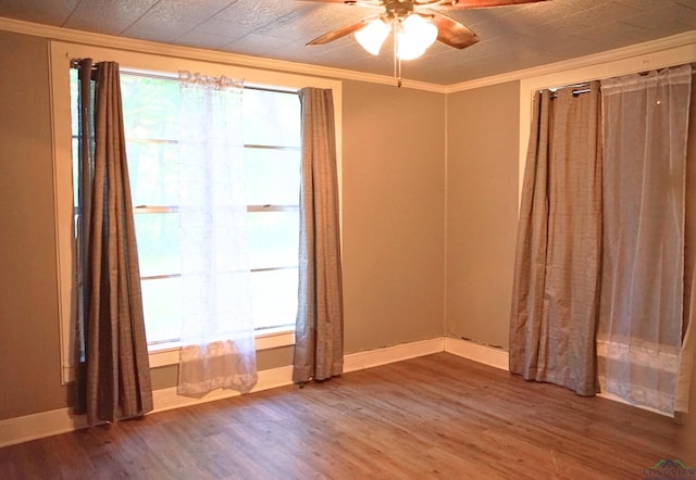 empty room with hardwood / wood-style flooring, ceiling fan, and ornamental molding