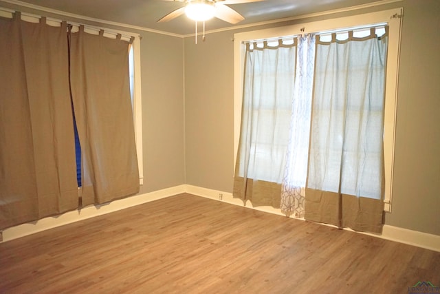 spare room featuring hardwood / wood-style floors, ceiling fan, and ornamental molding