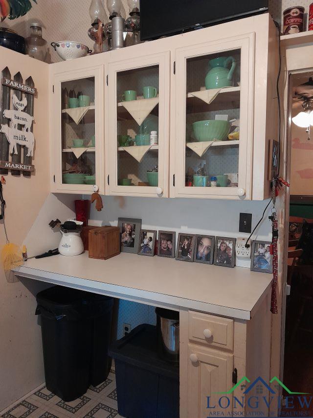 kitchen with built in desk and white cabinets