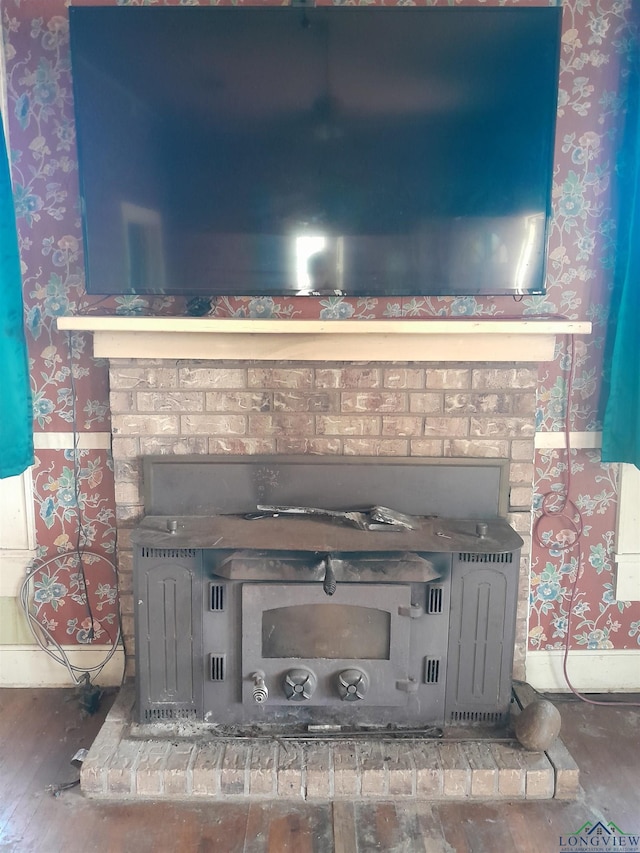 details featuring wood-type flooring and a wood stove