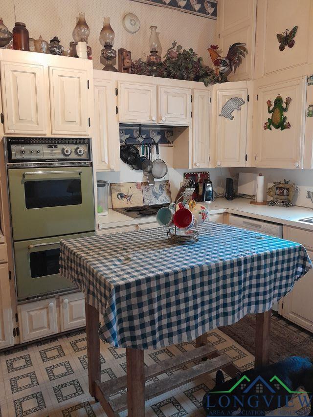 kitchen featuring double wall oven and white dishwasher