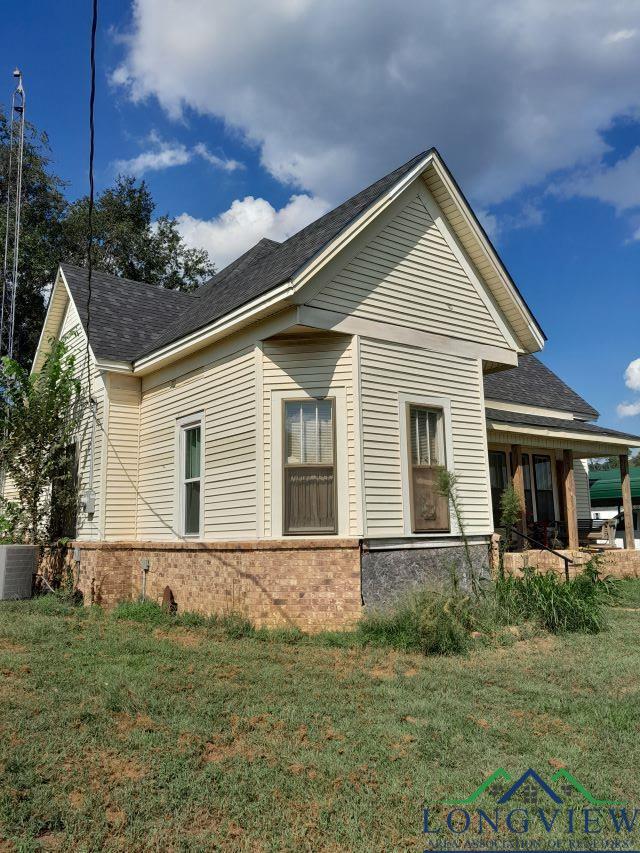 view of side of property with a patio and a yard