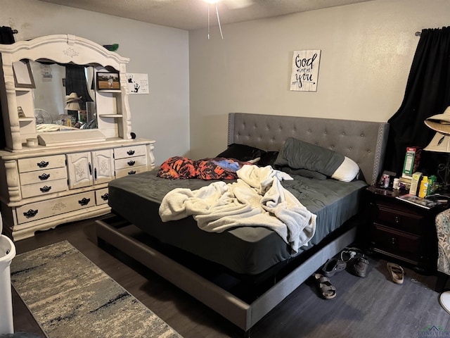 bedroom with dark wood-type flooring