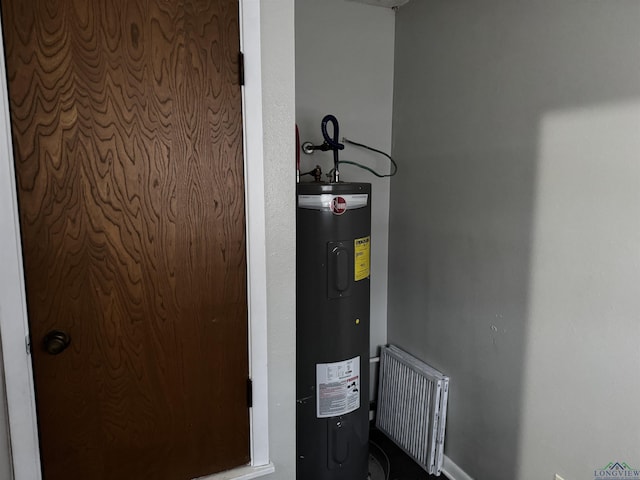 utility room featuring water heater and visible vents