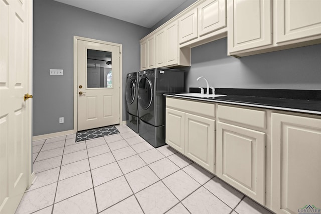 1804 W Lake Dr, Gladewater, TX 75647 - washroom featuring cabinets, light tile patterned floors, washing machine and dryer, and sink