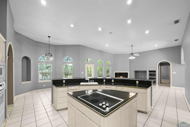 1804 W Lake Dr, Gladewater, TX 75647 - kitchen with a center island, white appliances, and light tile patterned floors