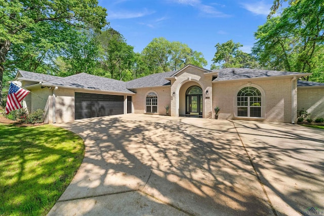 view of front of home featuring a garage and a front lawn