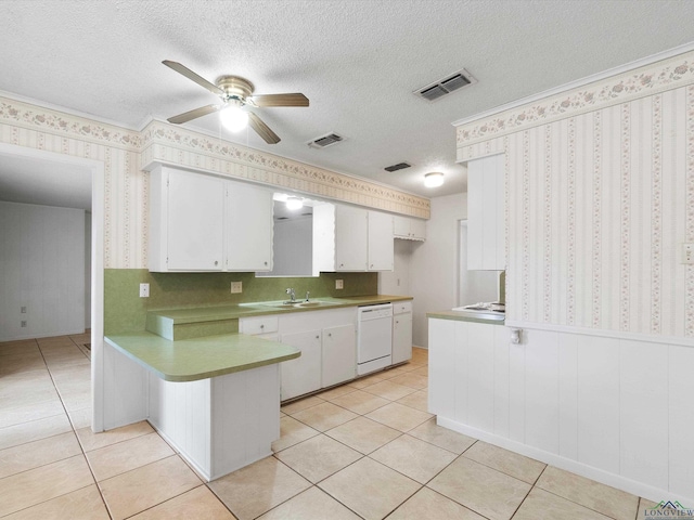 kitchen featuring kitchen peninsula, a textured ceiling, light tile patterned floors, dishwasher, and white cabinetry