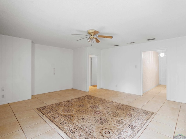 spare room featuring ceiling fan and light tile patterned floors