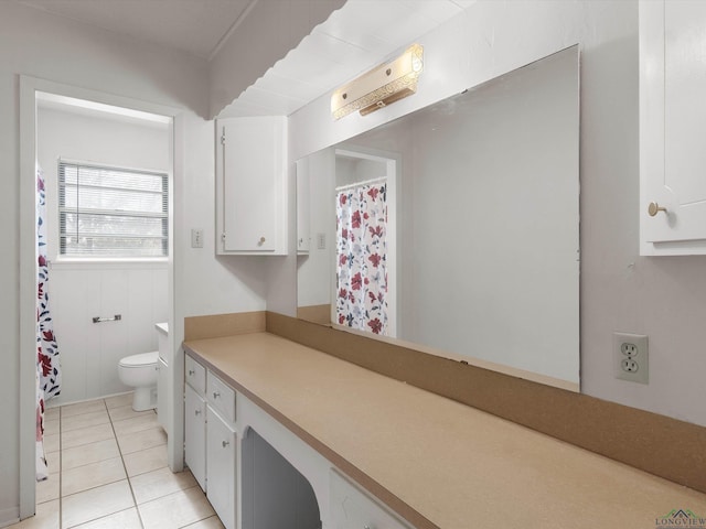 bathroom with tile patterned flooring, vanity, and toilet