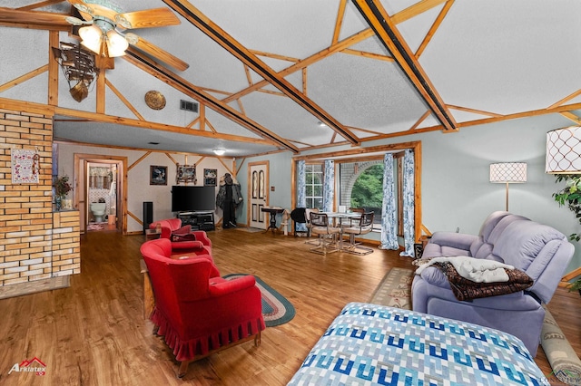 453 Wiggins Rd, Karnack, TX 75661 - living room with wood finished floors, a ceiling fan, and high vaulted ceiling