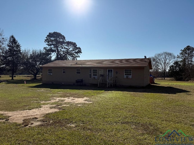 rear view of property with a yard