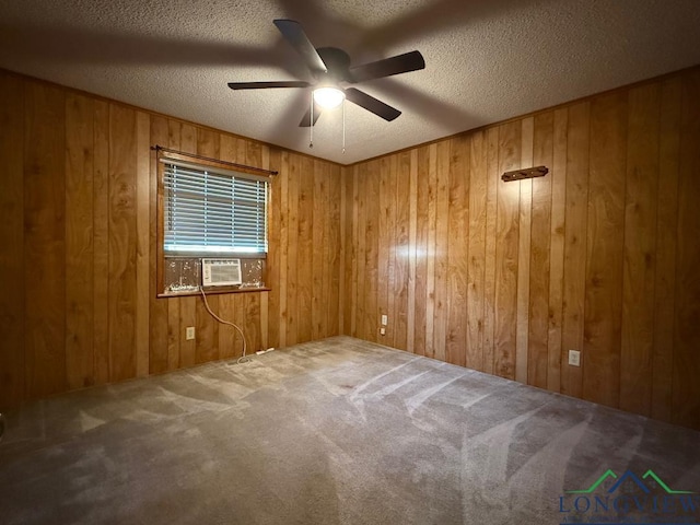 unfurnished room with carpet flooring, ceiling fan, a textured ceiling, and wooden walls