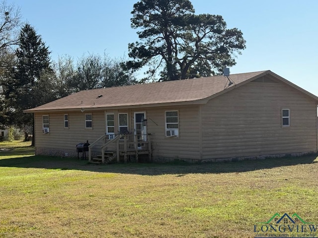 rear view of property featuring a yard