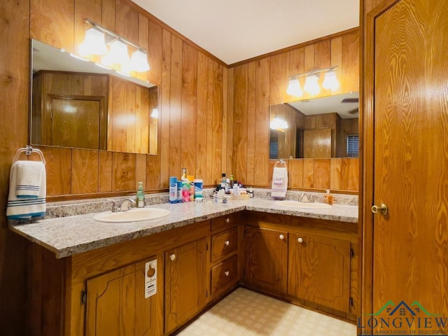 bathroom featuring wood walls and vanity