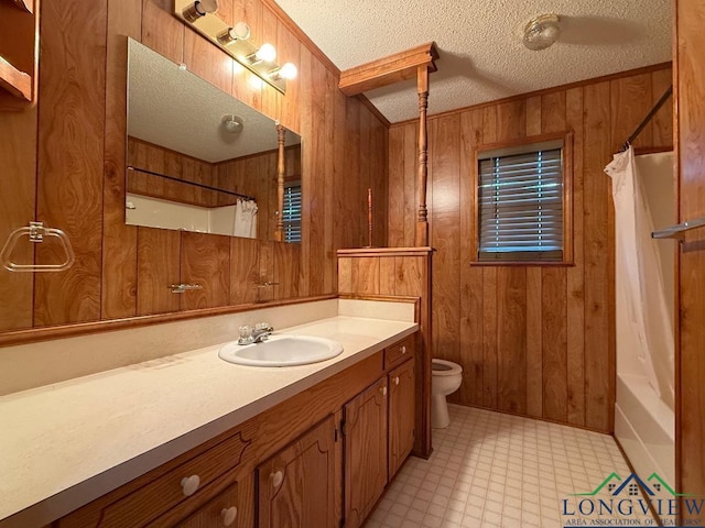 full bathroom featuring vanity, a textured ceiling, toilet, and wooden walls