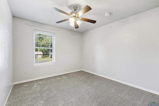 empty room featuring carpet floors, a textured ceiling, baseboards, and ceiling fan