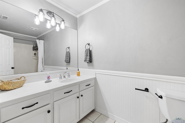 bathroom featuring visible vents, a wainscoted wall, vanity, and toilet