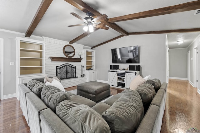 living area featuring wood finished floors, baseboards, and ceiling fan