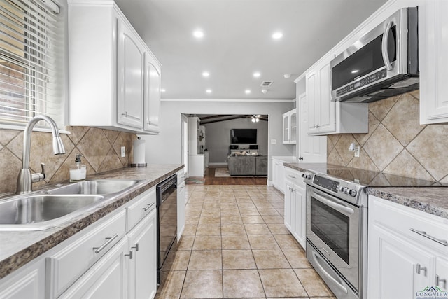 kitchen featuring a sink, ceiling fan, stainless steel appliances, white cabinetry, and ornamental molding