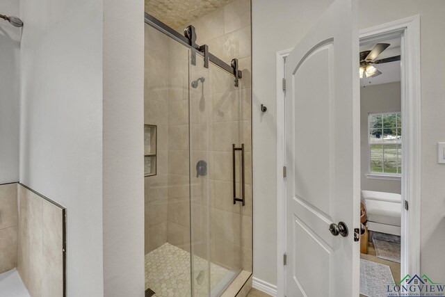 17255 Stella Maris St, Winona, TX 75792 - ensuite bathroom featuring ensuite bath, a stall shower, and ceiling fan