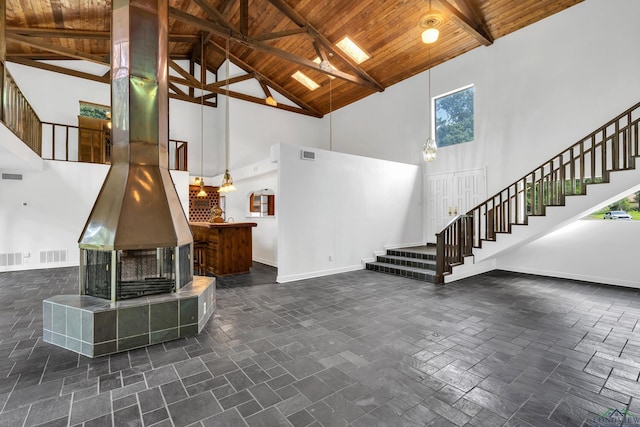 living room featuring beam ceiling, high vaulted ceiling, and wooden ceiling