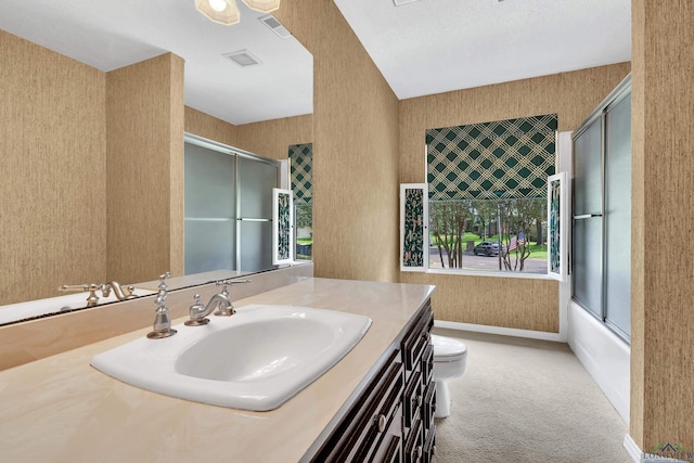 full bathroom featuring vanity, toilet, plenty of natural light, and enclosed tub / shower combo