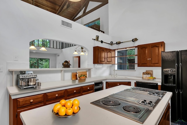 kitchen with decorative backsplash, sink, black appliances, beam ceiling, and high vaulted ceiling