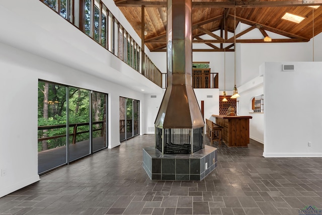 living room with beamed ceiling, wooden ceiling, and high vaulted ceiling