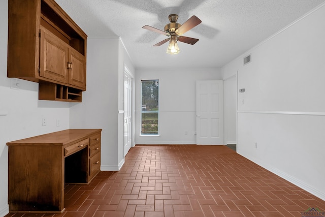 interior space with ceiling fan, crown molding, and a textured ceiling