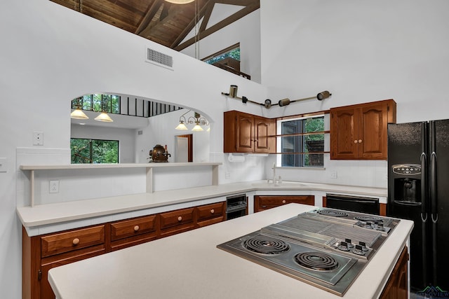 kitchen with sink, black appliances, high vaulted ceiling, beamed ceiling, and hanging light fixtures