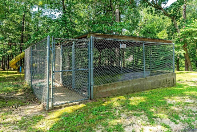 view of gate featuring an outbuilding