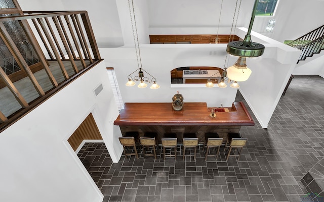 dining area with a high ceiling and a notable chandelier