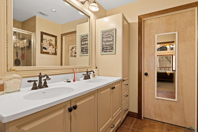 full bath featuring a sink, visible vents, tile patterned floors, double vanity, and a stall shower