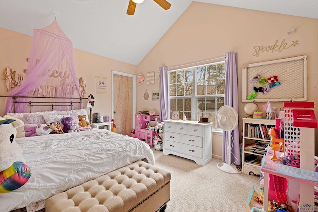 carpeted bedroom with ceiling fan and high vaulted ceiling