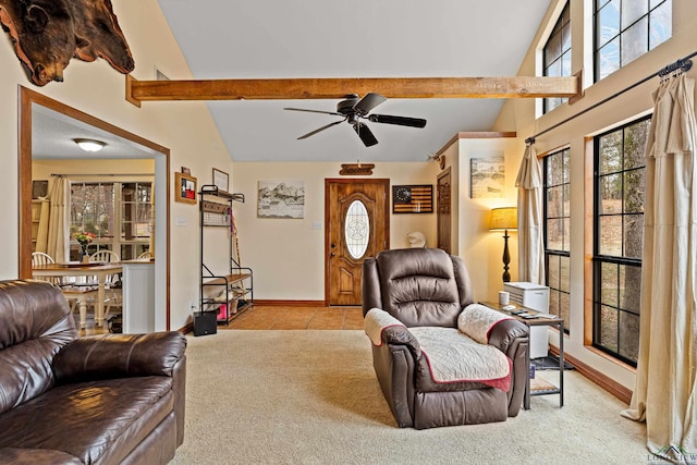 carpeted living area with vaulted ceiling with beams, ceiling fan, tile patterned floors, and baseboards