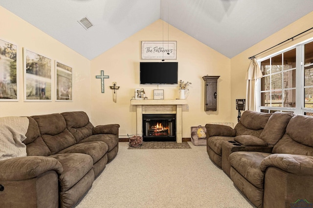 living room featuring carpet floors, a fireplace with flush hearth, visible vents, and vaulted ceiling