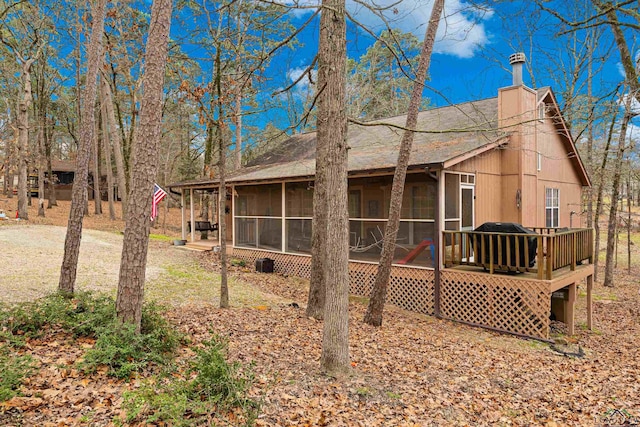 rear view of property with a sunroom