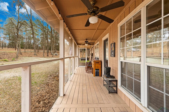 wooden terrace featuring ceiling fan