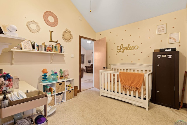 carpeted bedroom with lofted ceiling and a crib