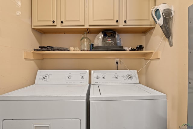 laundry area featuring separate washer and dryer and cabinet space