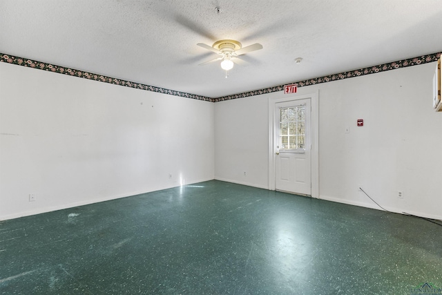 empty room featuring a textured ceiling and ceiling fan