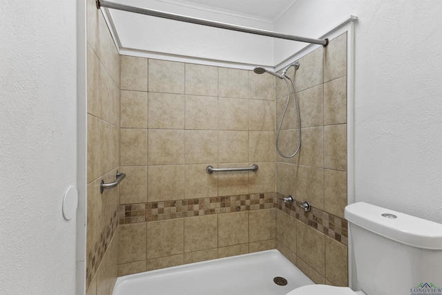 bathroom with tiled shower and toilet