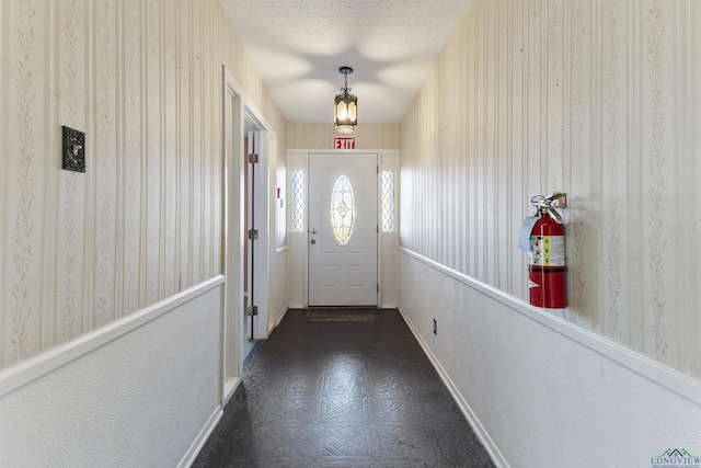 entryway with a textured ceiling